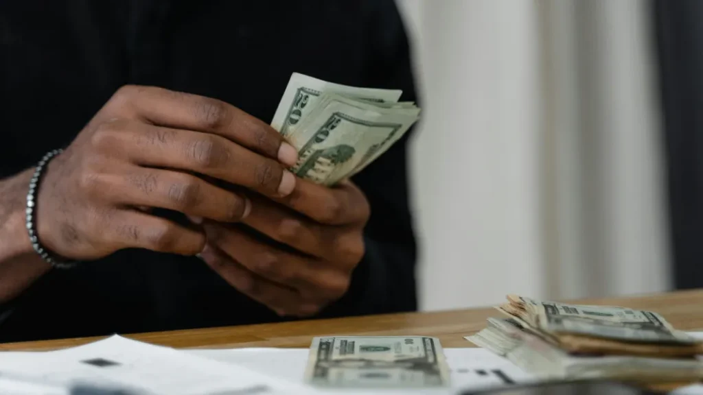 Man counting money navigating pay transparency